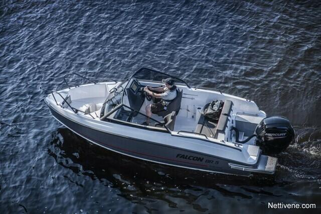 A person operates a white Falcon BR 3 boat on calm waters, showcasing outdoor recreation and boating activities.